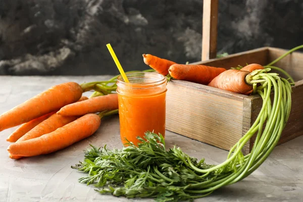 Jar of tasty carrot juice on grey table — Stock Photo, Image