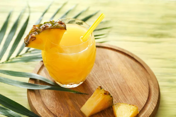 Glass of tasty pineapple juice on wooden board — Stock Photo, Image