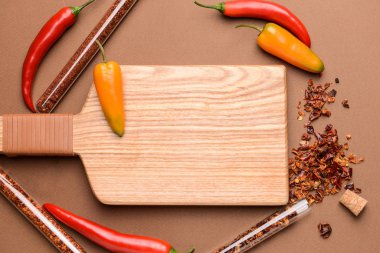 Renkli arka planda ahşap tahta ile tüpler kuru biber