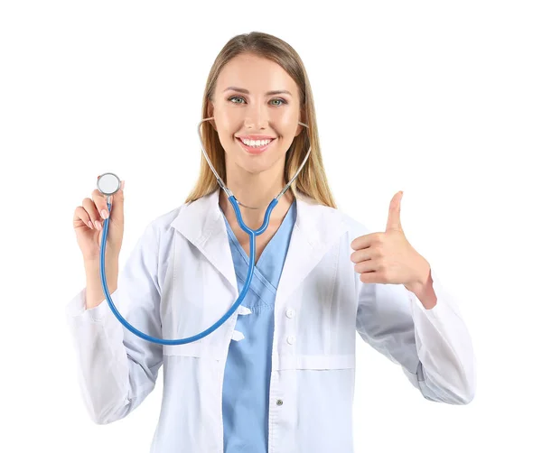 Female doctor with stethoscope showing thumb-up on white background — Stock Photo, Image