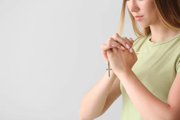 Religious young woman praying on white background — Stock Photo, Image