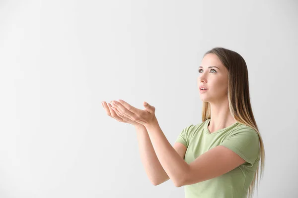 Religious young woman praying on white background — Stock Photo, Image