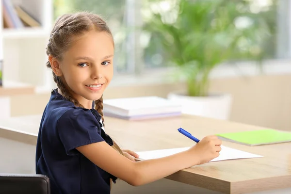 Pupil passing school test in classroom