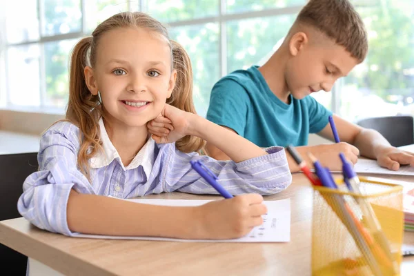 Pupils passing school test in classroom