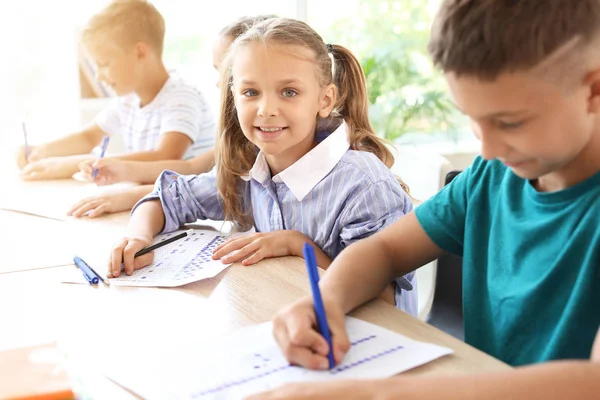 Pupils passing school test in classroom — Stock Photo, Image