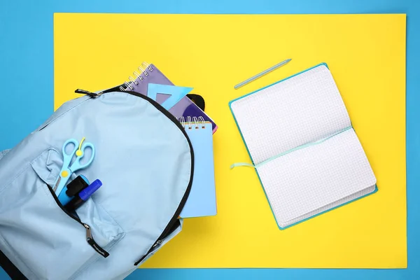 School backpack and stationery on color background — Stock Photo, Image