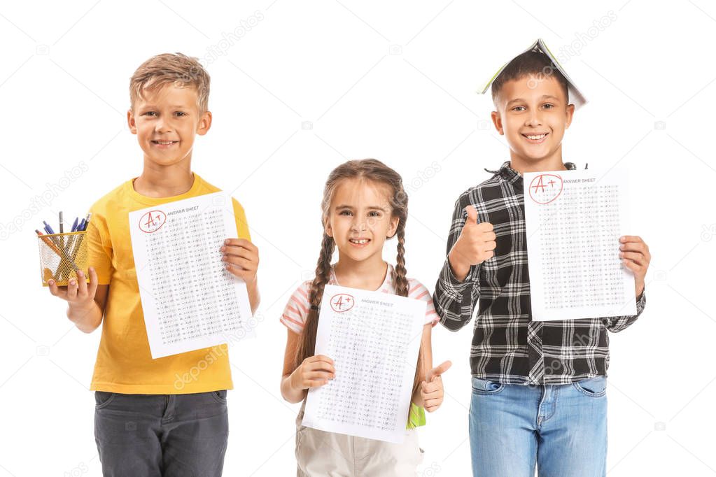 Happy children with answer sheets for school test on white background