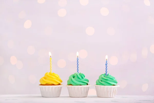 Tasty Birthday cupcakes against defocused lights — Stock Photo, Image