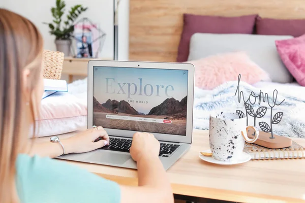 Woman with laptop visiting travel agency website at home — Stock Photo, Image