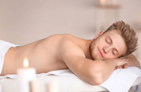 Handsome young man relaxing in spa salon — Stock Photo, Image