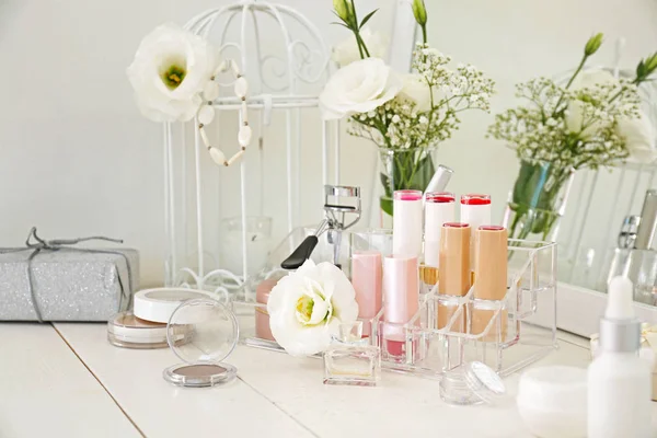 Makeup cosmetics on white dressing table — Stock Photo, Image