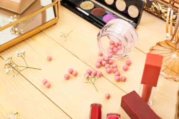 Makeup cosmetics on wooden dressing table — Stock Photo, Image