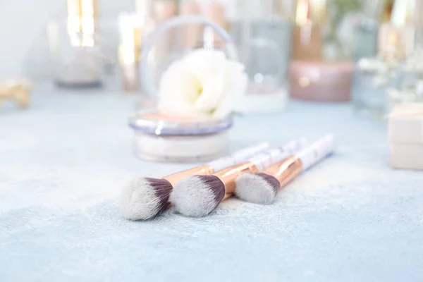 Makeup brushes on dressing table — Stock Photo, Image