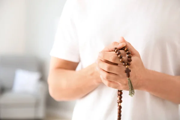 Religious man praying to God at home, closeup — Stock Photo, Image