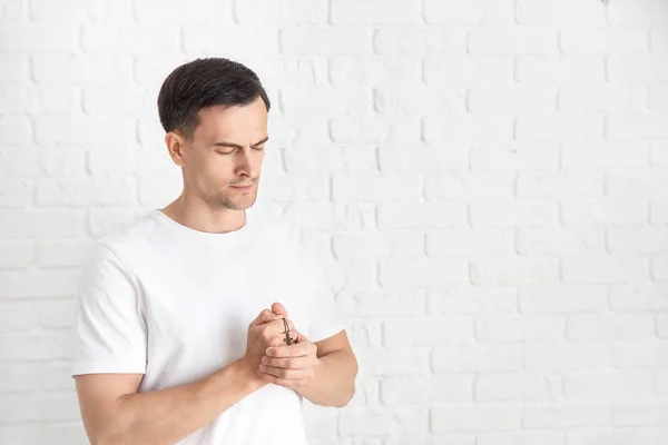 Religious man praying to God on white background — Stock Photo, Image