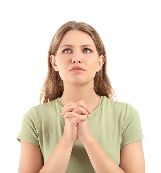 Mujer joven religiosa rezando a Dios sobre fondo blanco — Foto de Stock