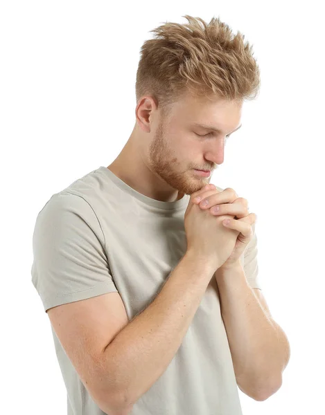 Θρησκευόμενος νέος άνθρωπος προσεύχεται στο Θεό σε λευκό φόντο — Φωτογραφία Αρχείου