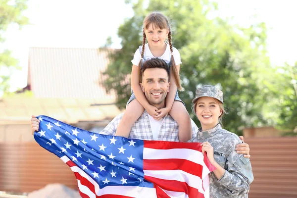 Happy female soldier with USA flag and her family outdoors — Stock Photo, Image