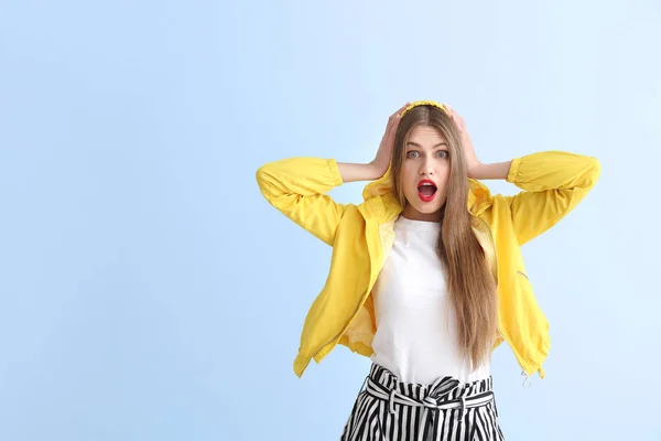 Mujer joven sorprendida sobre fondo de color —  Fotos de Stock