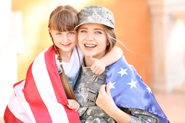 Feliz soldado femenino con su hija al aire libre — Foto de Stock