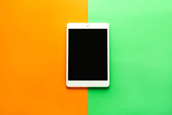 Modern tablet computer on color background — Stock Photo, Image