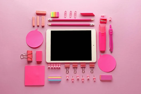 Computador tablet moderno e artigos de papelaria sobre fundo de cor — Fotografia de Stock