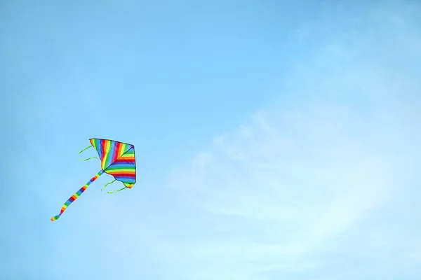 Colorful kite flying in blue sky — Stock Photo, Image