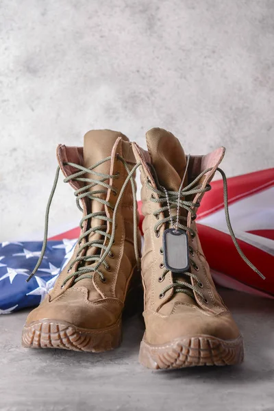 Botas militares y bandera de EE.UU. en la mesa — Foto de Stock