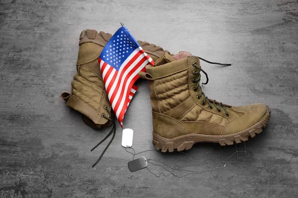 Military boots, USA flag and dog tags on grey background — Stock Photo, Image