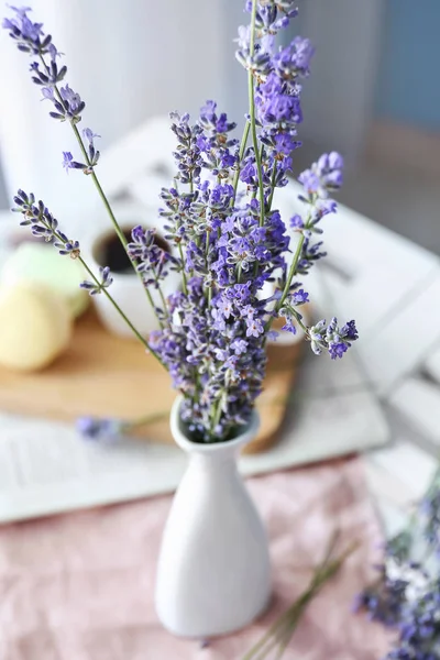 Beautiful lavender flowers in vase on table, closeup