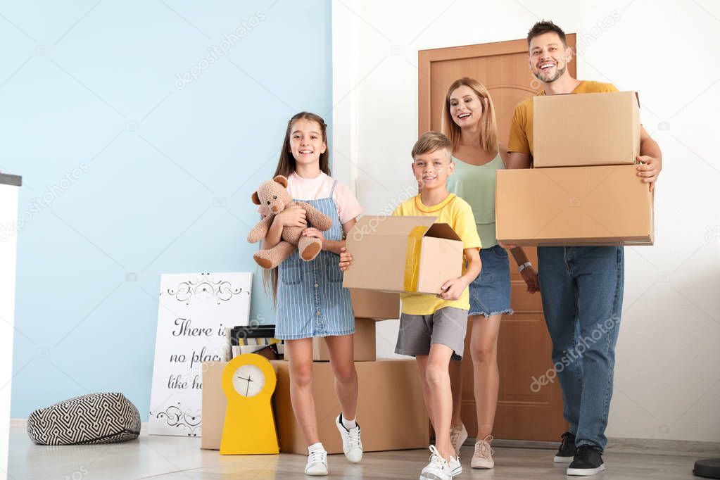 Happy family with belongings in their new house