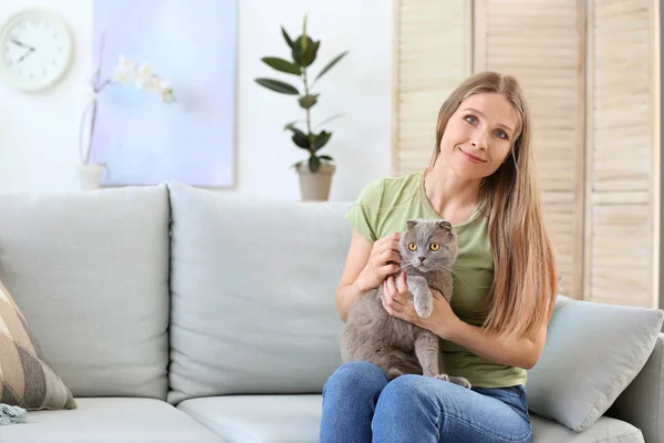Beautiful woman with cute cat at home