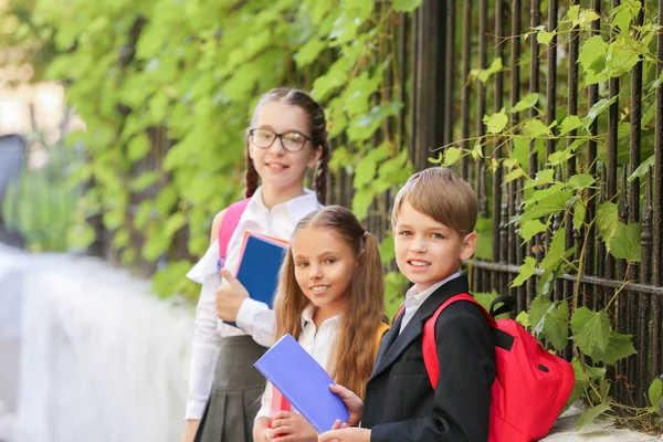 Cute little pupils after classes outdoors — Stock Photo, Image