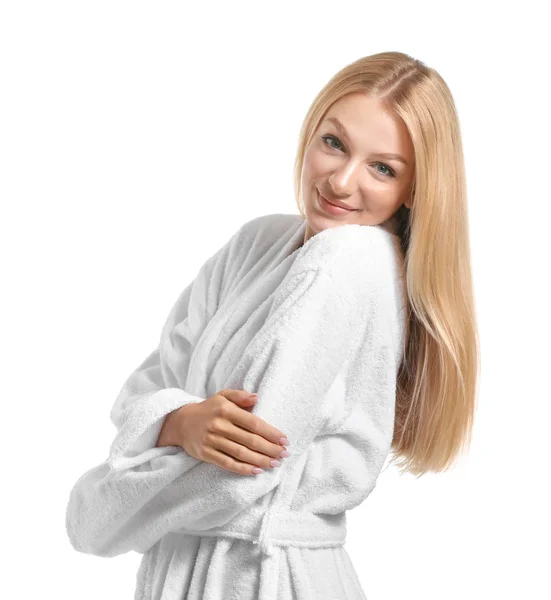 Beautiful young woman in bathrobe on white background — Stock Photo, Image