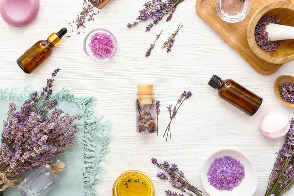 Lavender flowers with cosmetics on white wooden background — Stock Photo, Image