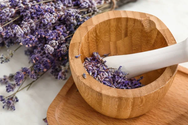 Lavender flowers with mortar on table — Stock Photo, Image