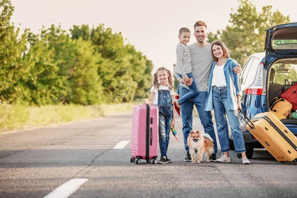 Happy family with luggage near car outdoors — Stock Photo, Image