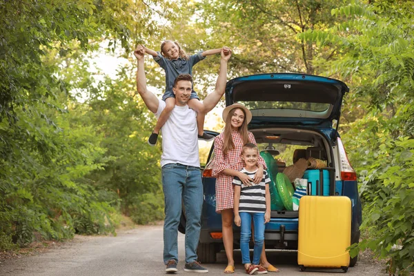 Happy family near car with luggage outdoors — Stock Photo, Image