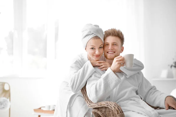 Morning of happy young couple in bathrobes at home — Stock Photo, Image