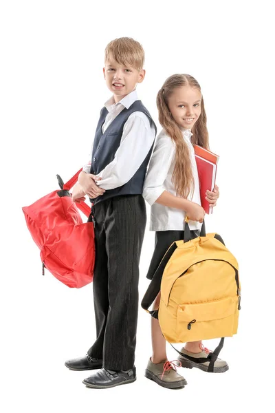 Carino piccoli alunni su sfondo bianco Foto Stock