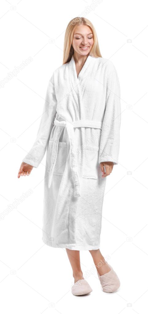 Beautiful young woman in bathrobe on white background