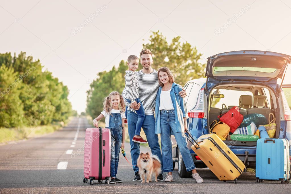 Happy family with luggage near car outdoors