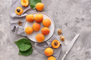 Gri arka planda lezzetli kayısı ile tabak