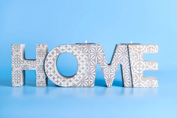 Portavelas en forma de palabra HOME sobre fondo de color — Foto de Stock