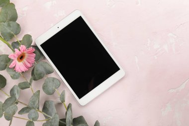Okaliptüs ve renkli arka planda çiçek ile modern tablet bilgisayar