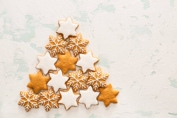 Tasty Christmas cookies on light background