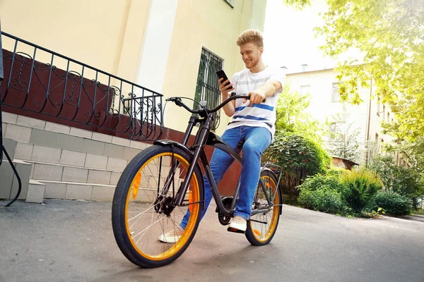 Young man riding bicycle outdoors — Stock Photo, Image