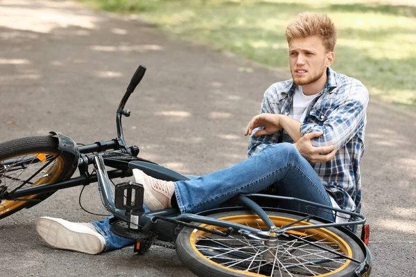 Joven caído de su bicicleta al aire libre — Foto de Stock