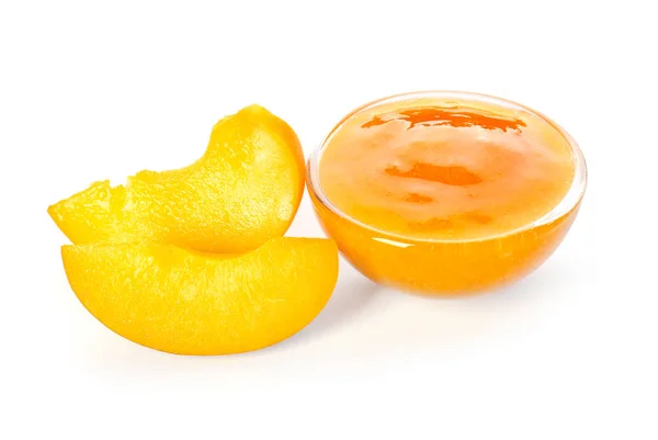 Bowl with tasty apricot jam on white background — Stock Photo, Image
