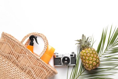 Plaj çantası, ananas ve beyaz arka planda fotoğraf kamerası
